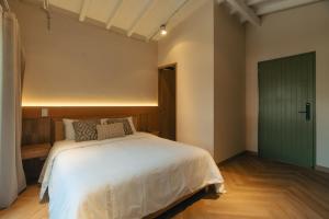 Voodi või voodid majutusasutuse Hotel Boutique Roomzz Laureles toas