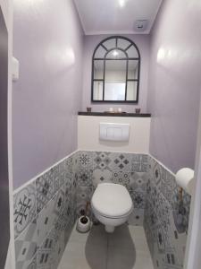 a bathroom with a white toilet and a window at Vespa Casa in Cherbourg en Cotentin +16 photos