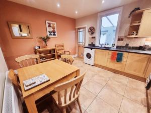 a kitchen and dining room with a table and chairs at Central Lancaster City Centre Terraced Gem in Lancaster