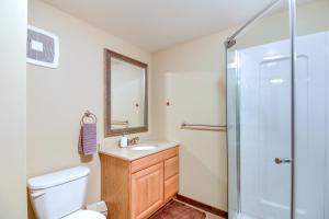 a bathroom with a toilet and a sink and a shower at Beautiful Breezy Point Home with Beach and Dock! in Pequot Lakes +35 photos