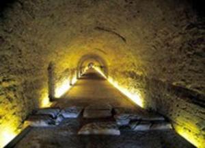 a tunnel with a light at the end of it at Plaça De La Font in Tarragona