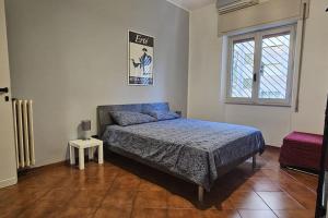 a bedroom with a bed and a window at Casa Paola al Tuscolano in Rome