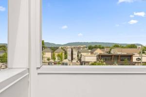 an open window with a view of a city at South Side Modern - Downtown Living - Amazing Location in Chattanooga