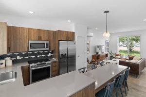 a kitchen with stainless steel appliances and a living room at South Side Modern - Downtown Living - Amazing Location in Chattanooga +39 photos