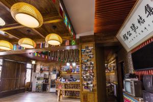 a store with wooden walls and ceiling with chinese signs at Zhangjiajie Jijiehao Inn in Zhangjiajie