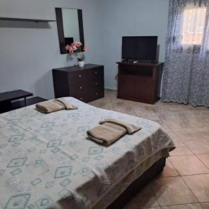 a bedroom with a bed with two towels on it at Aliki's house in Líthion