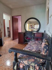 a room with a bed and a mirror at hacienda los tulipanes in Monterrey