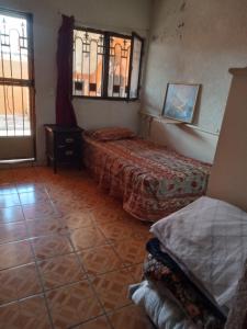 a room with two beds and a window at hacienda los tulipanes in Monterrey