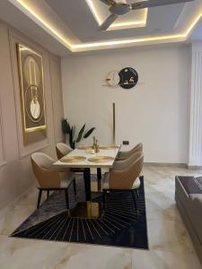 a dining room with a table and chairs at H4N Apartments in Cape Coast