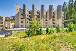 een appartementengebouw met hoge gebouwen op de achtergrond bij Ski-InandSki-Out Retreat with Iron Horse Pool Access! in Winter Park