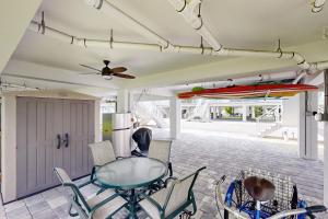 a dining room with a glass table and chairs at Mermaid's Retreat in Marathon
