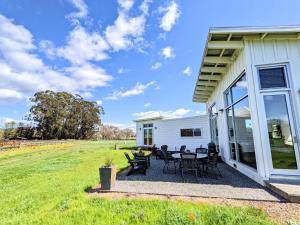 a patio with tables and chairs on the side of a house at Sonoma-Napa Wine Country Retreat Surrounded By Vineyards, Views, & Privacy in Sonoma