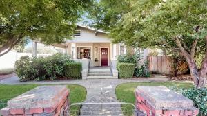 a white house with a red door and trees at Bungalow At Sonomas Historic Plaza! - Includes Wine Tasting Passport in Sonoma