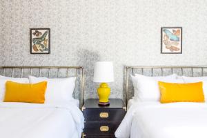 a bedroom with two beds and a lamp on a night stand at Inn at Gough in San Francisco