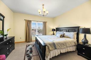 a bedroom with a bed and a window at Vacation Destination in Pigeon Forge +37 photos