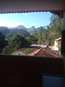a view of the mountains from a house at Suíte WILVIT in São Pedro da Serra