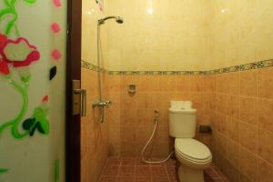 a bathroom with a toilet and a shower at KT. Kuaya Home Stay in Ubud +62 photos
