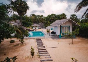 a house on the beach with a swimming pool at Bedrock Beach Villas in Kalpitiya