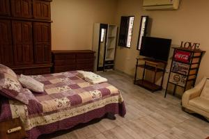 1 dormitorio con 1 cama, TV y vestidor en Dpto a 4 min del Shopping y Centro de Convenciones, en Corrientes