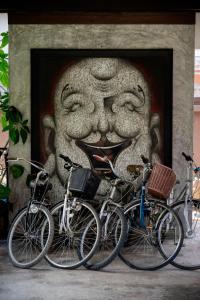 a group of bikes parked in front of a statue at Tolani Northgate Villa Chiang Mai in Chiang Mai
