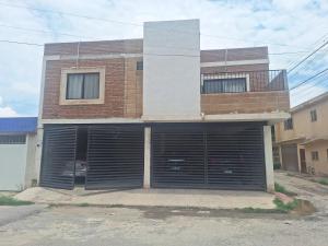 a house with two garage doors in front of it at Luki in El Tajito
