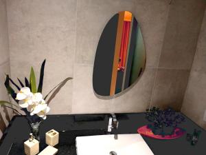 a bathroom with a sink and a mirror on the wall at Luxury Paiva Flat in Recife