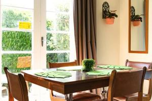 a dining room table with chairs and a large window at 6min to city centre - Cosy & Quiet Vintage Retreat in Christchurch +15 photos