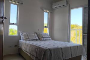 a bed in a room with two windows at Mareazul Ubatuba in Ubatuba +30 photos