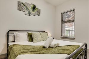 a bedroom with a bed with white sheets and a window at Tasteful 2BR I Pool I Gym I Parking I Workspace in Dallas