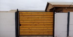 a wooden gate in front of a house at Herradura Sur Oriente in Coquimbo