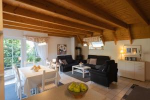 a living room with a table and a dining room at Ferienhaus "Nanni" Wittsand 04 in Dorum-Neufeld +31 photos