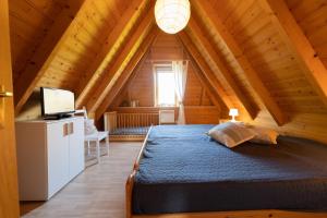 a bedroom with a bed in a wooden cabin at Ferienhaus "Nanni" Wittsand 04 in Dorum-Neufeld