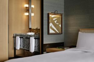 a hotel room with a bed and a sink at Park Hyatt Kyoto in Kyoto