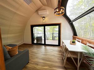 a living room with a table and a large window at Sunken Escapes Glamping Unit 4 in New Minas