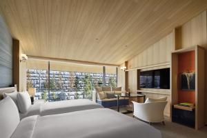 a hotel room with two beds and a television at Park Hyatt Kyoto in Kyoto
