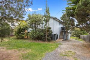 a white house with a yard in front of it at Smiths Beach Sanctuary in Smiths Beach