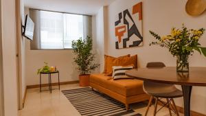 a living room with a couch and a table at Apartasuites ISABEL in Cali