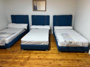two beds sitting in a room with wooden floors at جاردن سيتى in Cairo