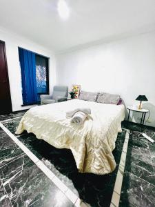 a white bedroom with a bed and a chair at 28 OFF Affordable Beautiful Queen Bedroom Near City Swan River Fremantle University in Perth