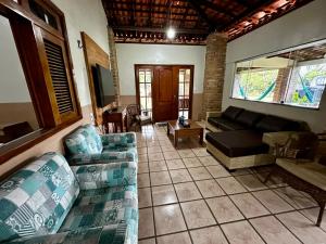 a living room with two couches and a couch at Sítio Encanto do Delta in Tutóia