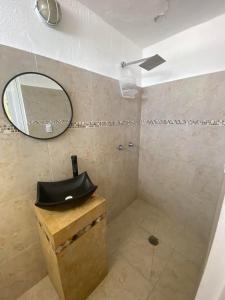 a bathroom with a mirror and a sink at Villa Panoramica 2 pisos, piscina vista al mar in Acapulco