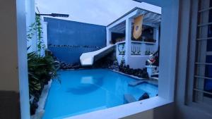 a swimming pool in the middle of a building at Room at Arthur Resort in Legazpi