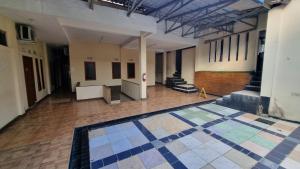 Ένα ή περισσότερα κρεβάτια σε δωμάτιο στο Wisma Alamanda