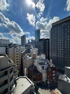 a view of a city with buildings and the sun at TOKYO EXPERT SHINJUKU in Tokyo