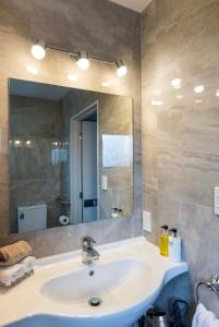 a bathroom with a sink and a large mirror at Two Tree Motel & Lodge in Blenheim +30 photos