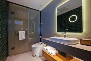 un bagno con lavandino, wc e doccia di Shijiazhuang Changan Wanda Plaza Jianhua City Plaza Qiuguo Hotel a Shijiazhuang Altre 11 foto