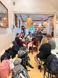 a group of people sitting at a table in a restaurant at Sanga Hostel in Pakse