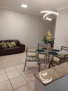 a living room with a table and chairs and a couch at Casa da Vó Cida in Espirito Santo Do Pinhal