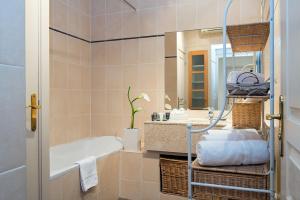 a bathroom with a tub and a sink at Aston - Appartement Centre Ville Massena in Nice +49 photos