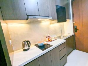 a kitchen with a sink and a counter top at Lovina 12- 20 at Pollux Meisterstadt in Batam Center
